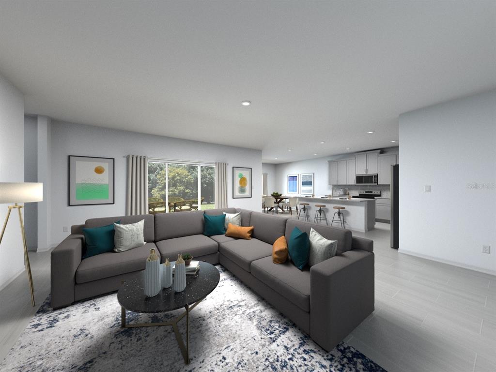 This digital rendering shows an open-concept living room with a sectional sofa and kitchen — 1697 COOLRIDGE PLACE, ZEPHYRHILLS, FL