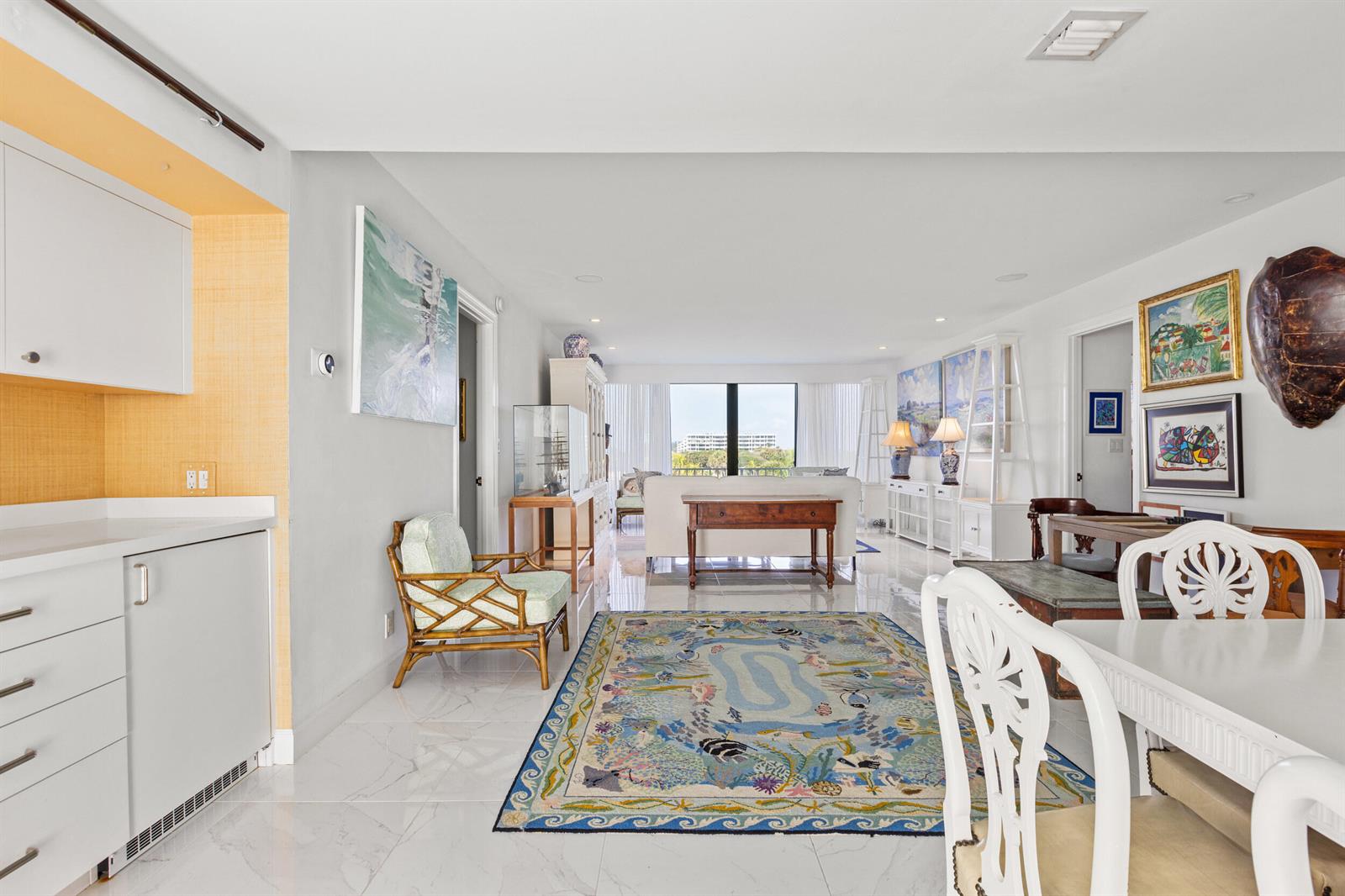 A bright living and dining area features white tile floors, a patterned rug, and furniture — 2275 S Ocean Boulevard # 307a, Palm Beach FL 33480, PALM BEACH, FL