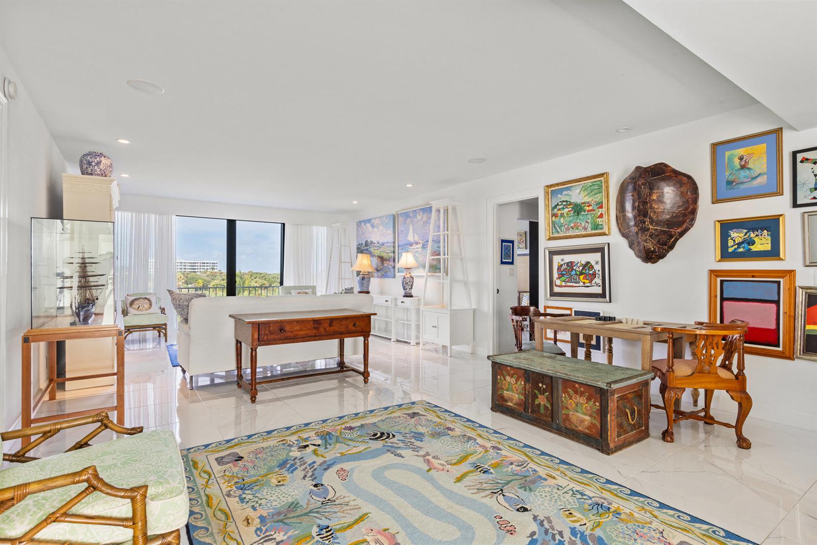 A bright living room features white tile floors, a patterned area rug, and wall-mounted artwork — 2275 S Ocean Boulevard # 307a, Palm Beach FL 33480, PALM BEACH, FL