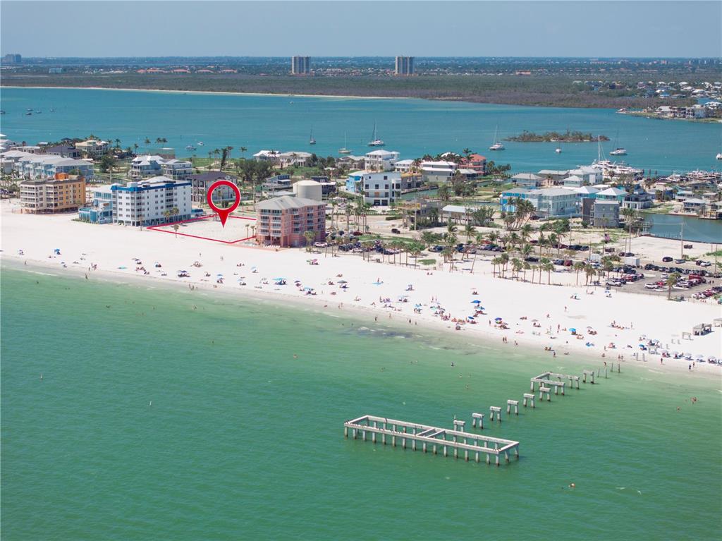 An aerial view shows a vacant beachfront lot marked with a red outline near buildings — 800-802 ESTERO BOULEVARD, FORT MYERS BEACH, FL