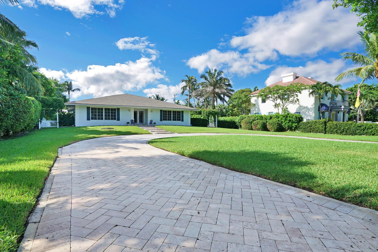 A white single-story house with a paved driveway and a large green lawn — 17 E Ocean Avenue, Ocean Ridge FL 33435, OCEAN RIDGE, FL