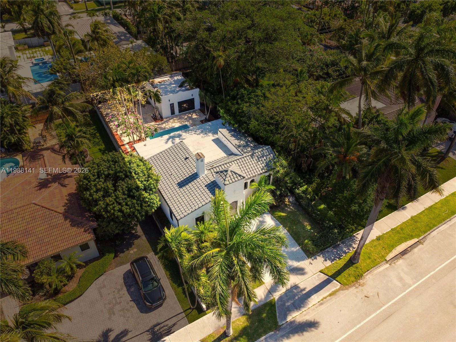 An aerial view shows a white house with a gray tiled roof and a pool — 1108 Harrison St, Hollywood FL 33019, HOLLYWOOD, FL