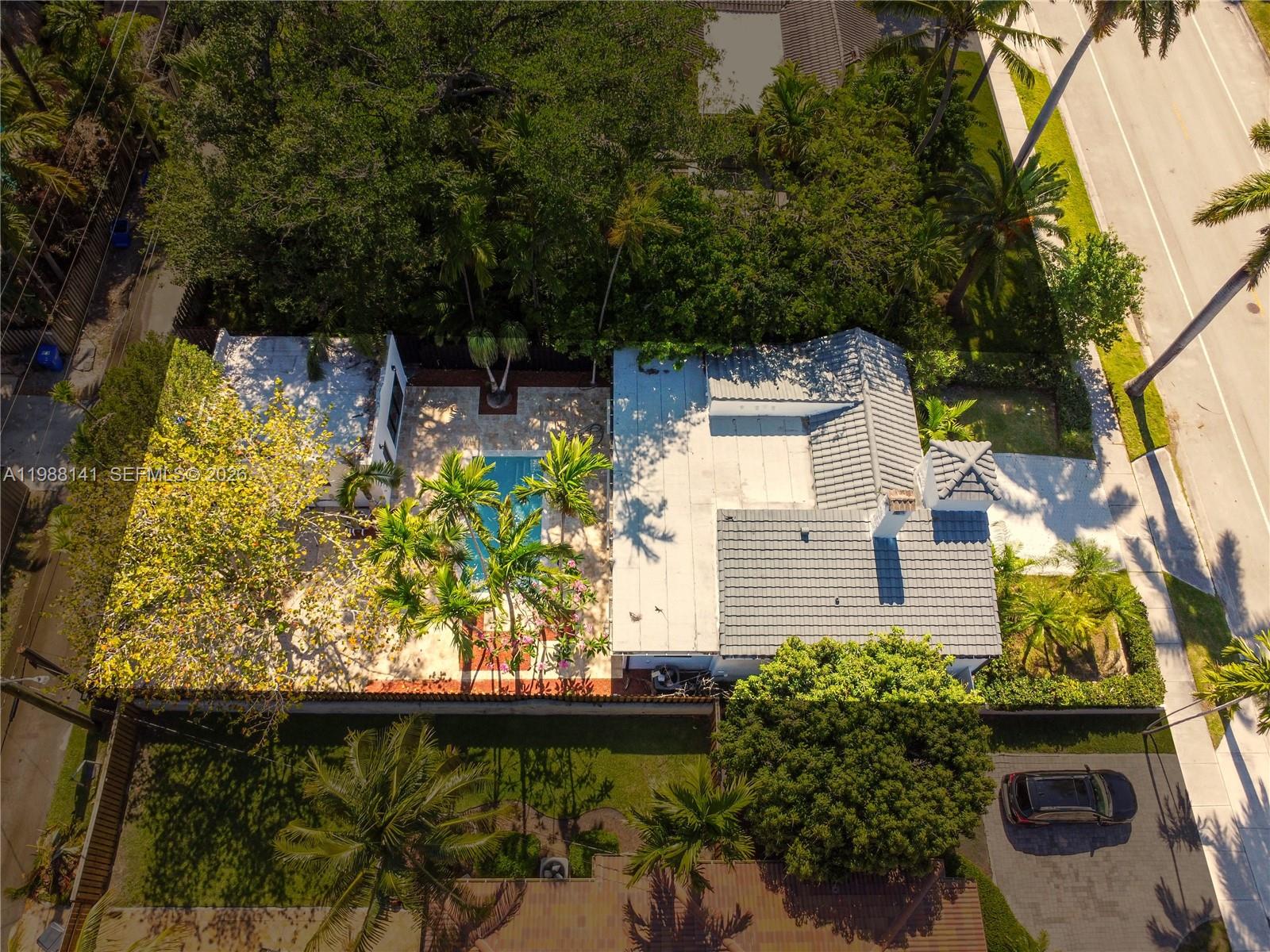 An aerial view shows a house with a pool, patio, and surrounding landscaping — 1108 Harrison St, Hollywood FL 33019, HOLLYWOOD, FL