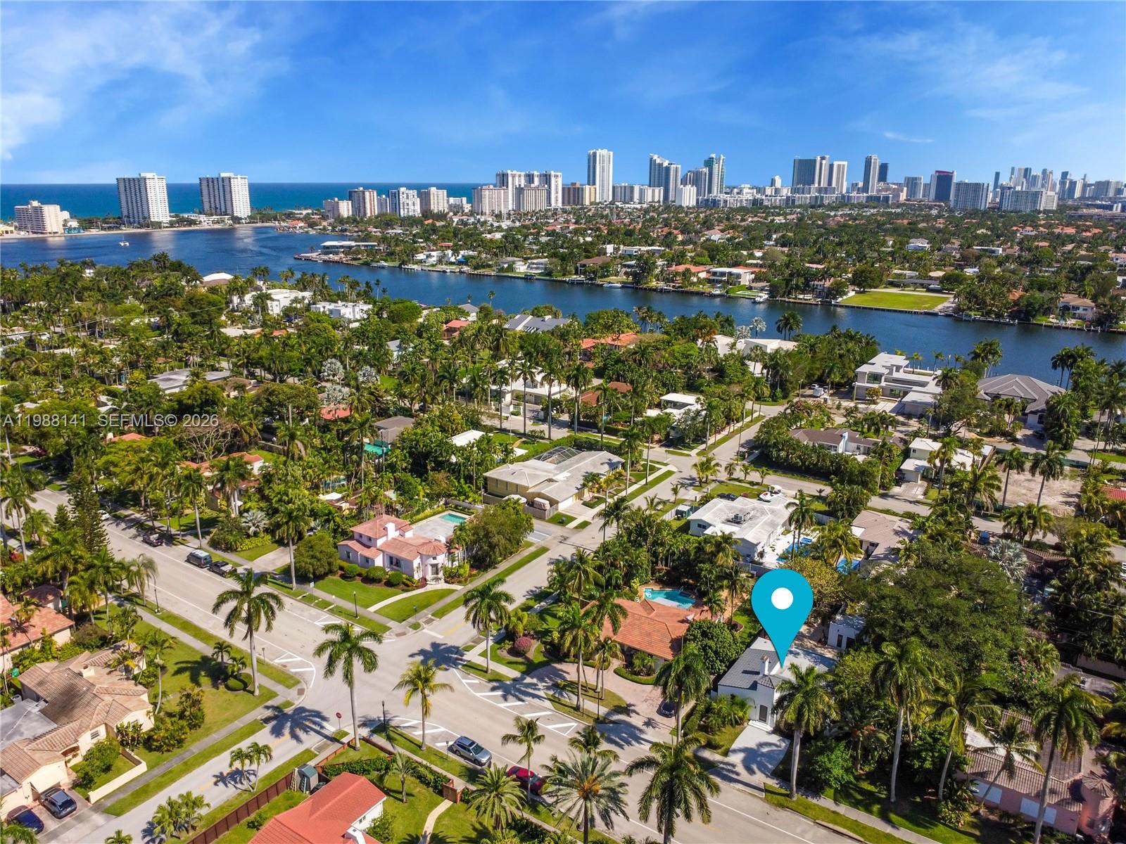 An aerial view shows a residential neighborhood with a marked house near a waterway — 1108 Harrison St, Hollywood FL 33019, HOLLYWOOD, FL