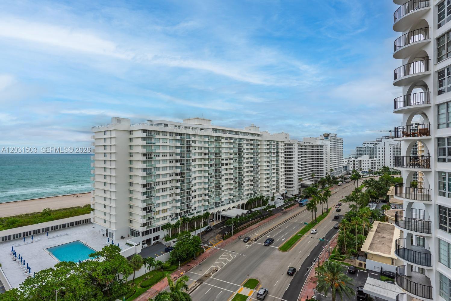 An elevated view shows a coastal high-rise building, a swimming pool, and a nearby road — 5660 Collins Ave # 14C, Miami Beach FL 33140, MIAMI BEACH, FL