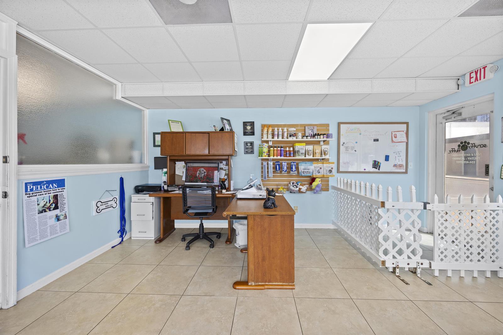 A reception area features a wooden desk, a white lattice gate, and a product display shelf — 101 NE 2nd Avenue, Deerfield Beach FL 33441, DEERFIELD BEACH, FL