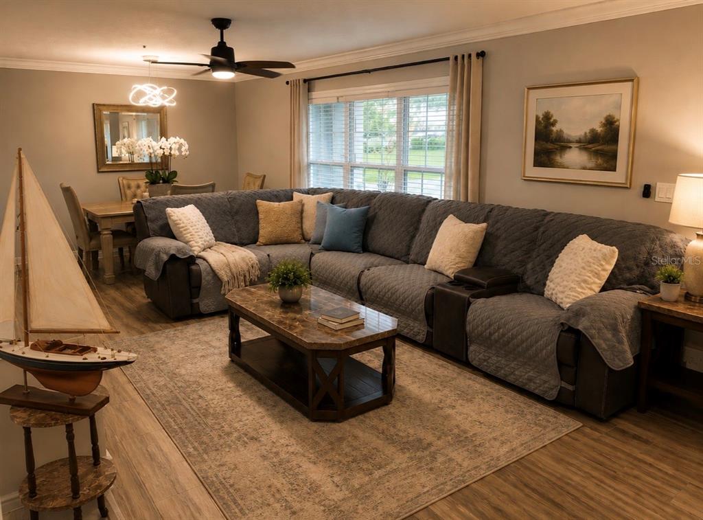 A living room features a large sectional sofa, a coffee table, and a model sailboat — 1623 WAVECREST STREET, MERRITT ISLAND, FL