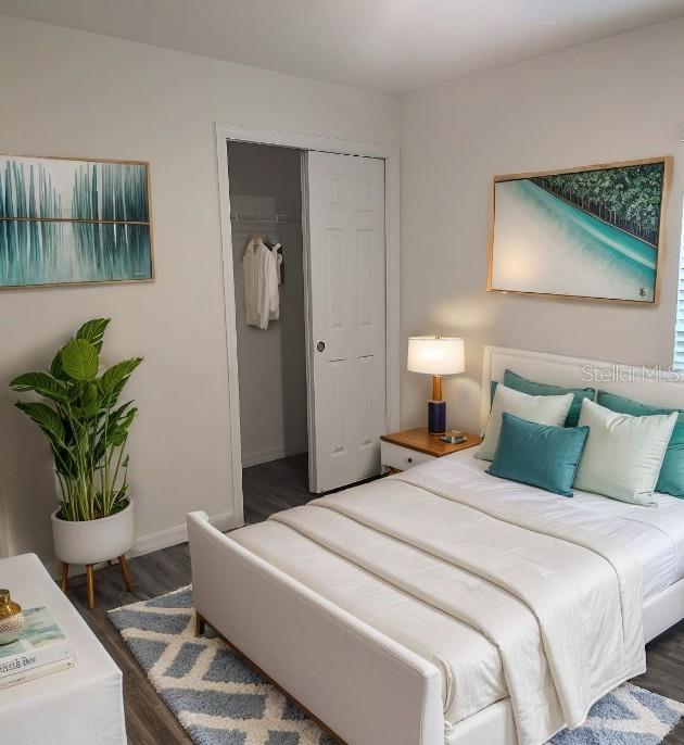 A bedroom features a bed with teal pillows, a potted plant, and two framed paintings — 1040 MELVILLE ROAD, PUNTA GORDA, FL