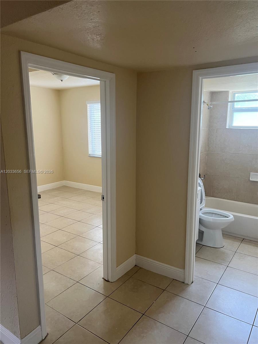 A tiled hallway leads to a bedroom on the left and a bathroom on the right — 5900 NW 1st Ave # 2, Miami FL 33127, MIAMI, FL