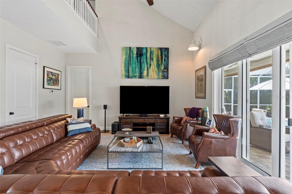 A kitchen features white cabinetry, a large stone island, and stainless steel appliances — 112 S FLORIDA AVENUE, TARPON SPRINGS, FL