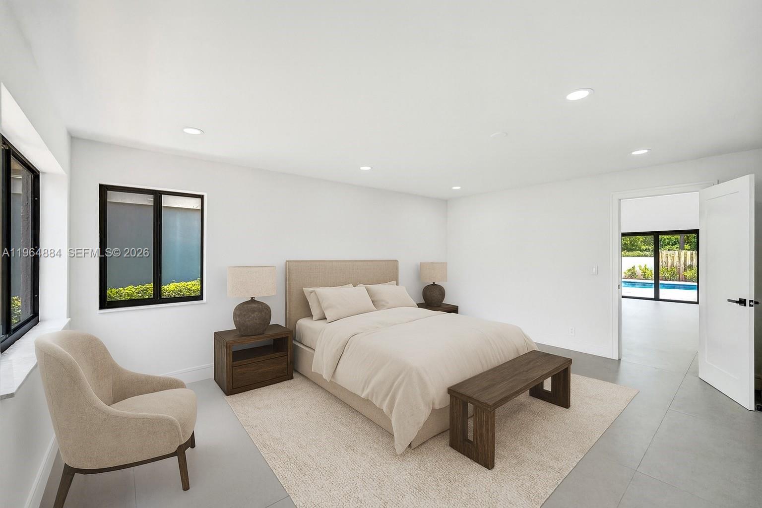 A bedroom features a bed, a bench, an armchair, and a view of a pool — 7340 Andorra Pl, Boca Raton FL 33433, BOCA RATON, FL