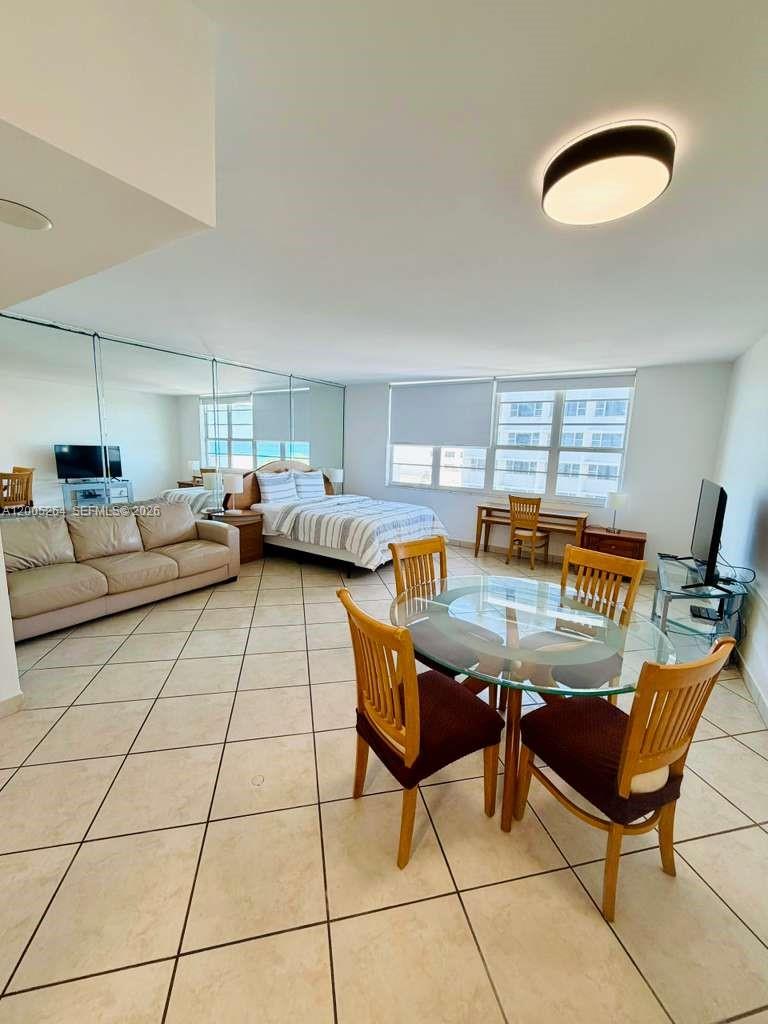 This studio apartment features a bed, sofa, dining set, and tiled flooring — 100 Lincoln Rd # 731, Miami Beach FL 33139, MIAMI BEACH, FL