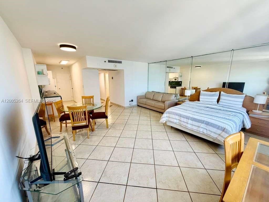 This studio apartment features a bed, sofa, dining area, and tiled floors — 100 Lincoln Rd # 731, Miami Beach FL 33139, MIAMI BEACH, FL