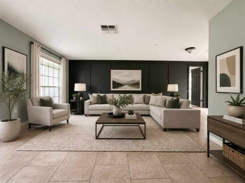 A living room features a large sectional sofa against a black paneled wall — 12407 WEATHERSTONE ROW, HUDSON, FL