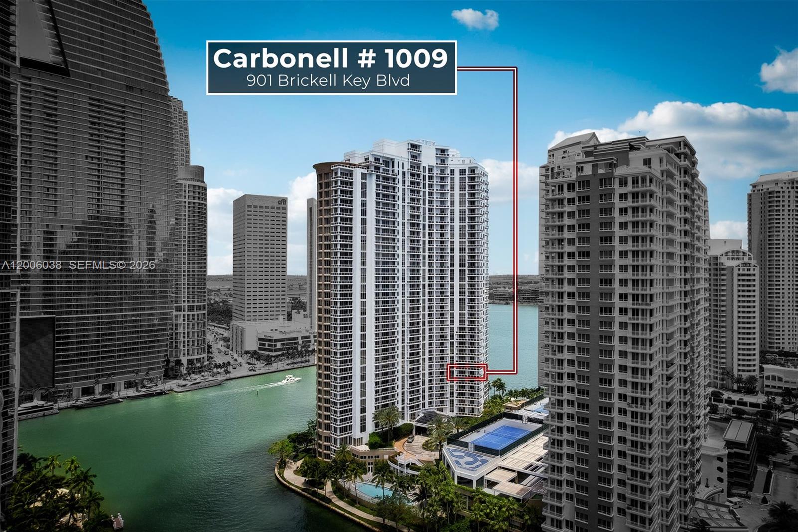 An aerial view shows a high-rise residential building on an island surrounded by water — 901 Brickell Key Blvd # 1009, Miami FL 33131, MIAMI, FL