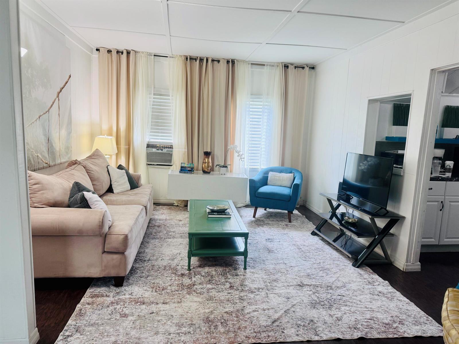 A living room features a beige sofa, a green coffee table, and a blue armchair — 204 S M Street, FL 33460, FL
