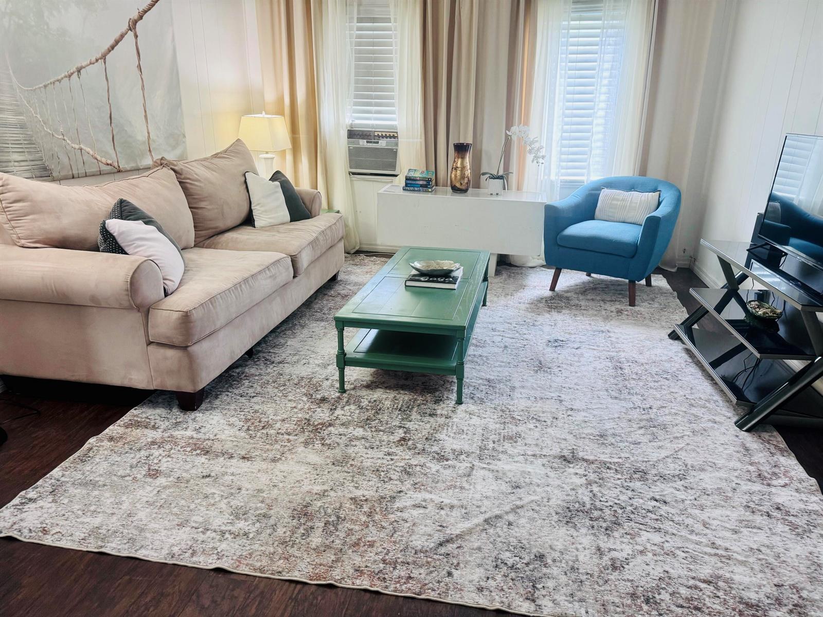 A living room features a beige sofa, a green coffee table, and a blue armchair — 204 S M Street, FL 33460, FL