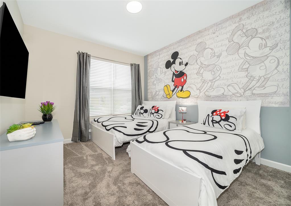 A bedroom features two twin beds with Mickey Mouse-themed bedding and a large character mural — 2764 BOOKMARK DRIVE, KISSIMMEE, FL