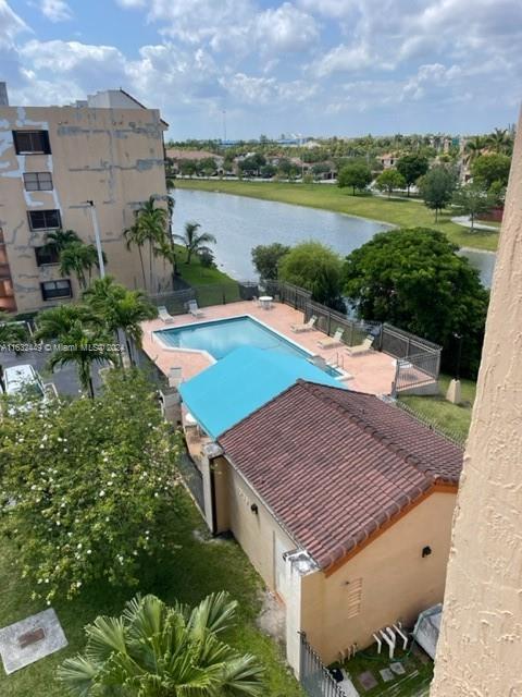 An elevated view shows a swimming pool, a tiled-roof building, and a lake — 10145 NW 9th St Cir # 502, Miami FL 33172, MIAMI, FL