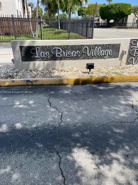 A stone monument sign displays the name Las Brisas Village near a paved road — 10145 NW 9th St Cir # 502, Miami FL 33172, MIAMI, FL