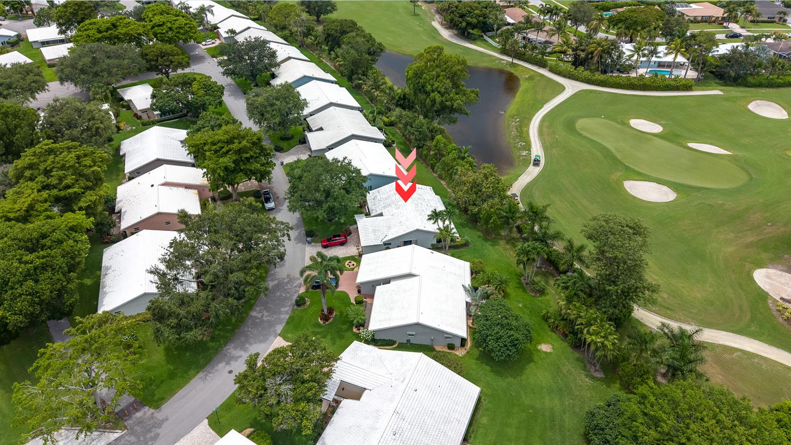 An aerial view shows a residential neighborhood with white-roofed townhomes bordering a golf course — 5557 N Cameo Drive N, Boca Raton FL 33433, BOCA RATON, FL