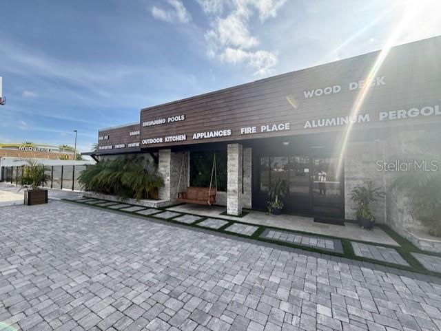 The exterior of a commercial building features a paved parking area and outdoor display signage — 3852 L B MCLEOD ROAD, ORLANDO, FL