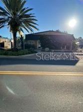 A street-level view shows a one-story commercial building with a palm tree in front — 305 MAIN STREET UNIT A, B & C, AUBURNDALE, FL