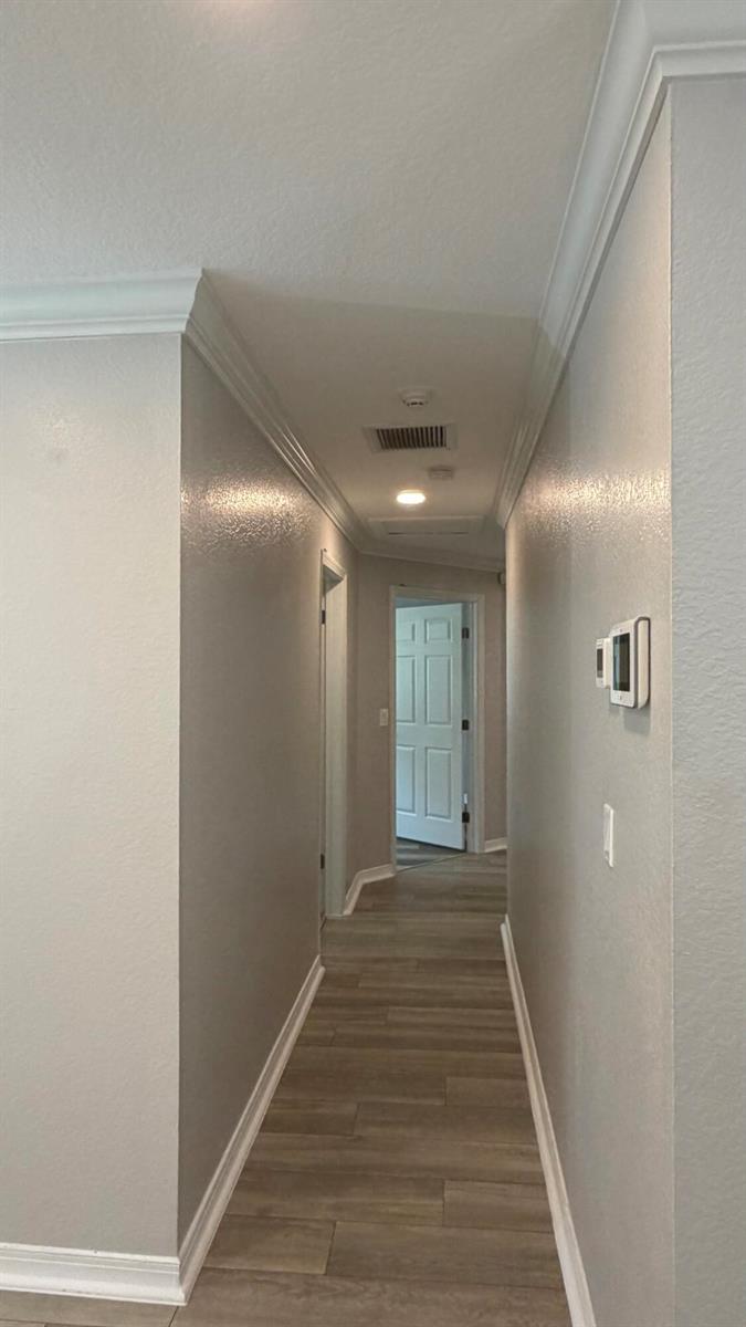 An empty room with gray walls, wood-look flooring, recessed lighting, and a blue front door — 128 NW 10th Avenue, Delray Beach FL 33444, DELRAY BEACH, FL