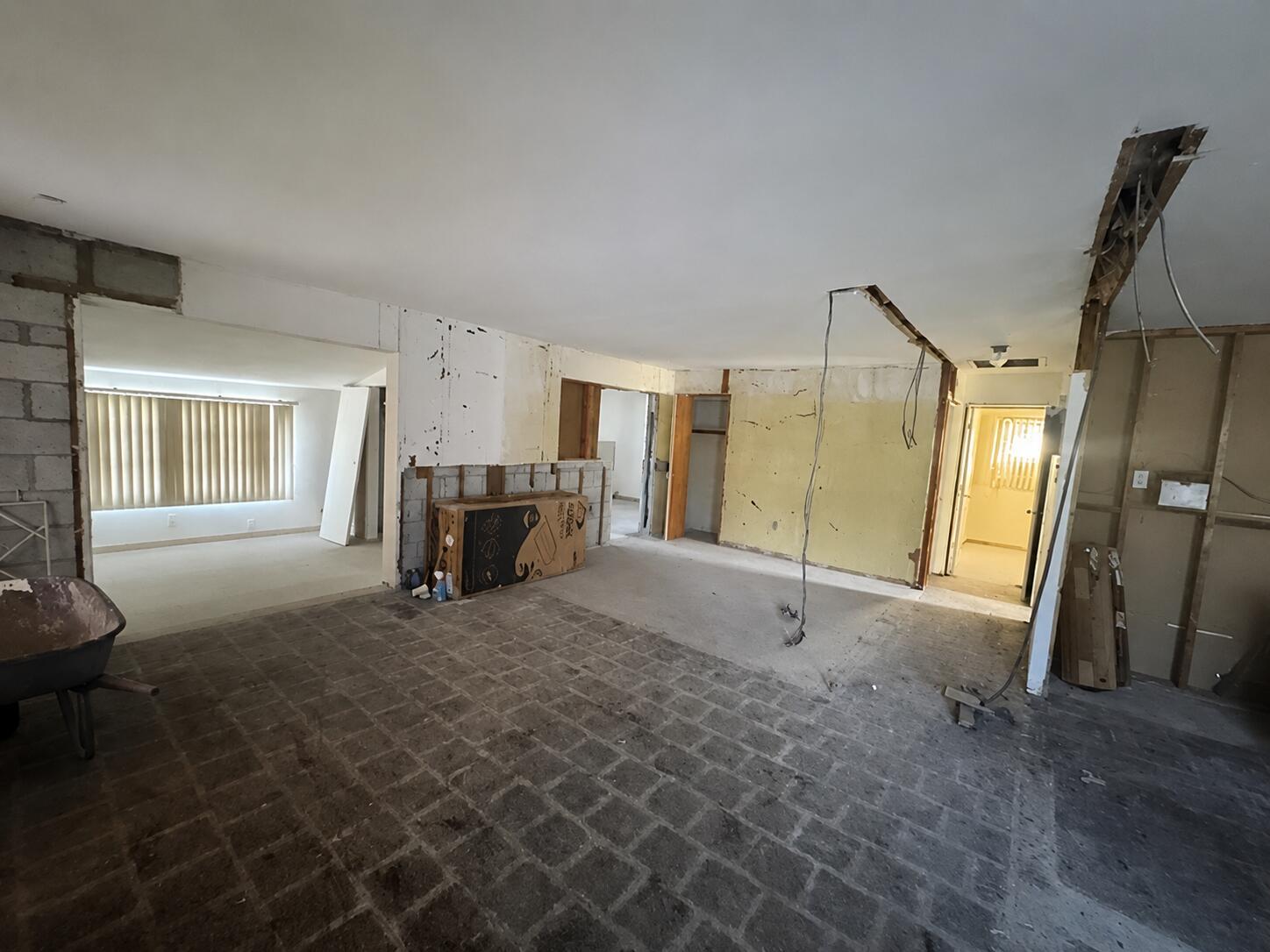 An unfinished interior space with exposed wall studs, concrete flooring, and an open floor plan — 1781 NW 6th Terrace, Pompano Beach FL 33060, POMPANO BEACH, FL