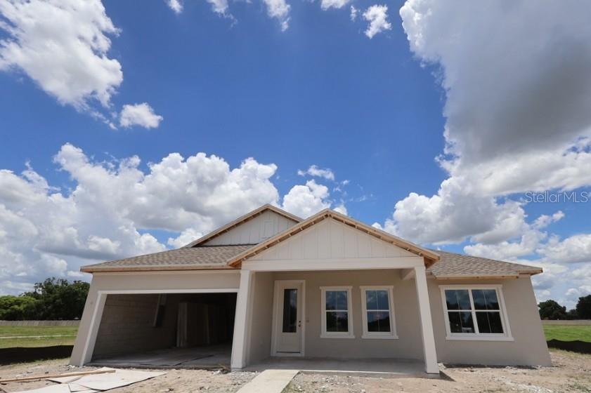 A newly constructed single-story house with a garage and a covered front porch — 314 STETSON RISE COURT, PLANT CITY, FL