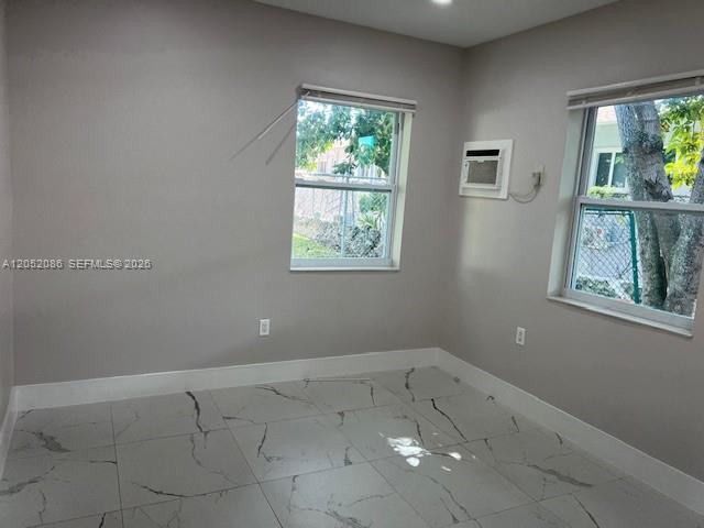 A room with light gray walls, white baseboards, and white marble-patterned tile flooring — 922 NW 2nd St # 4, Miami FL 33128, MIAMI, FL