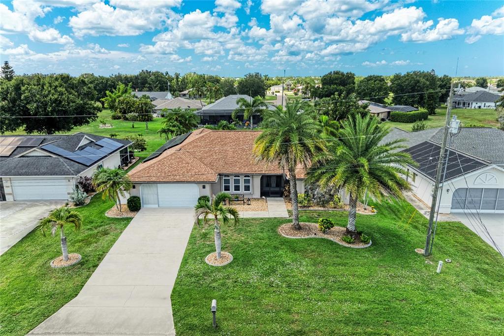 A screened-in swimming pool with a paver deck and a covered patio area — 25499 TERRAIN LANE, PUNTA GORDA, FL