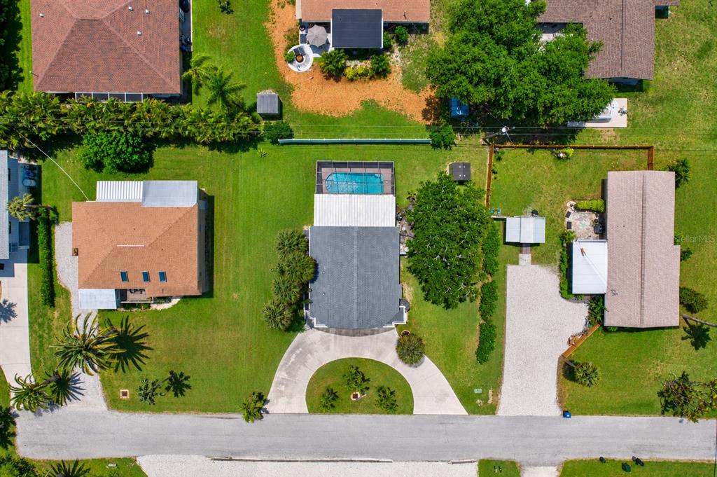 An aerial view shows three houses with yards, a swimming pool, and driveways — 1194 LINDEN ROAD, VENICE, FL