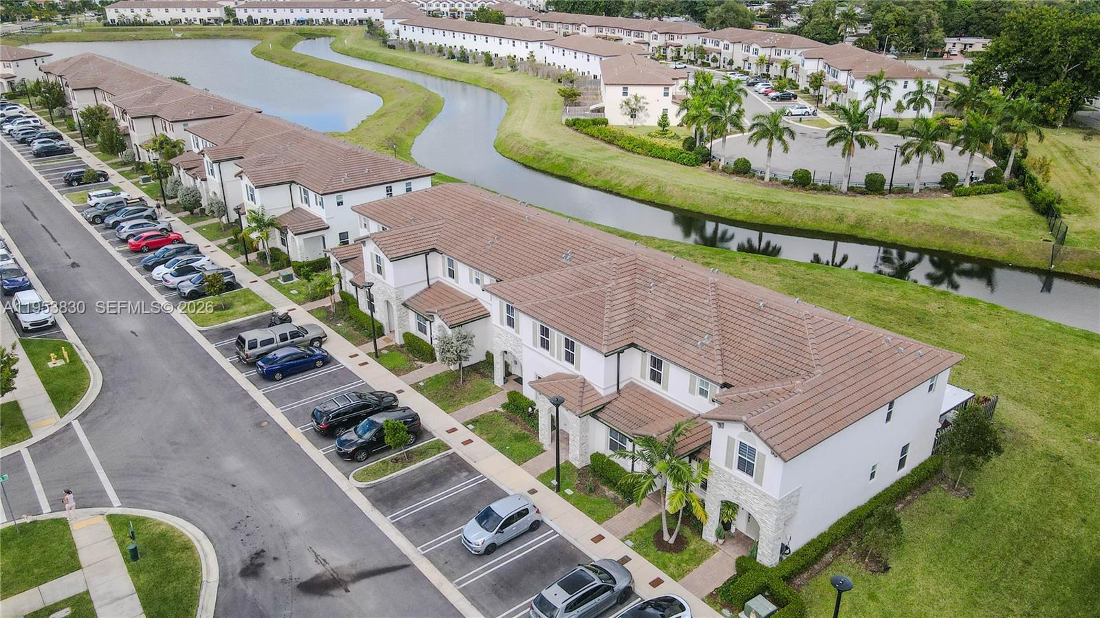 An aerial view shows a multi-unit residential building with a tiled roof and parking — 2313 NW 122nd Ter, Miami FL 33167, MIAMI, FL