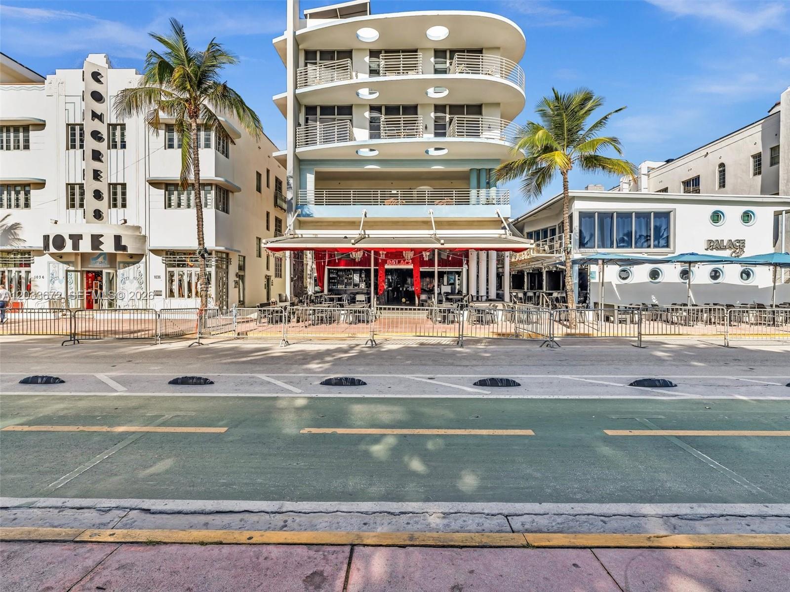 A street-level view of the Palace restaurant and adjacent buildings on a sunny day — 1052 Ocean Dr # C203, Miami Beach FL 33139, MIAMI BEACH, FL