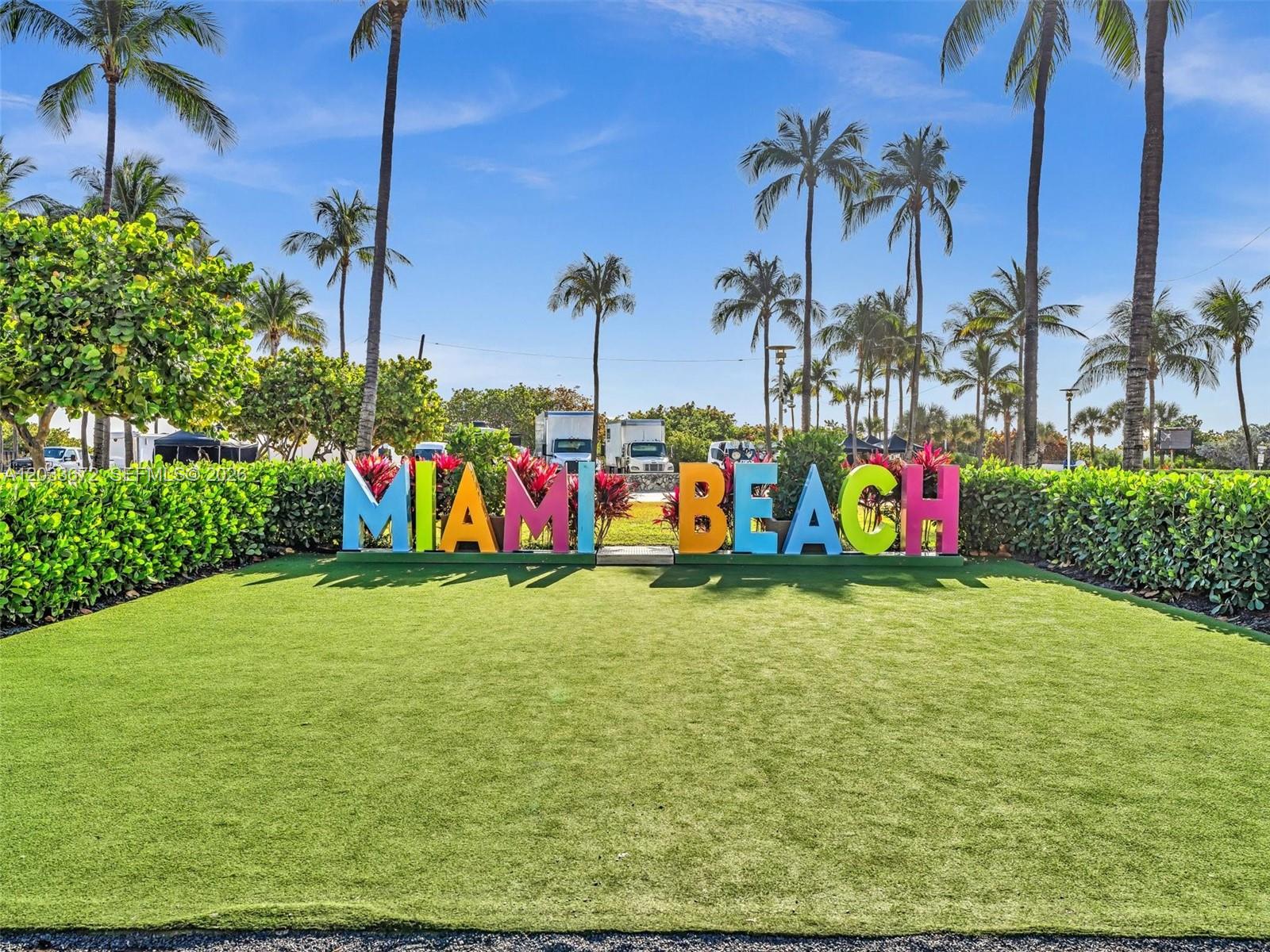 A colorful Miami Beach sign stands on a manicured lawn surrounded by palm trees — 1052 Ocean Dr # C203, Miami Beach FL 33139, MIAMI BEACH, FL