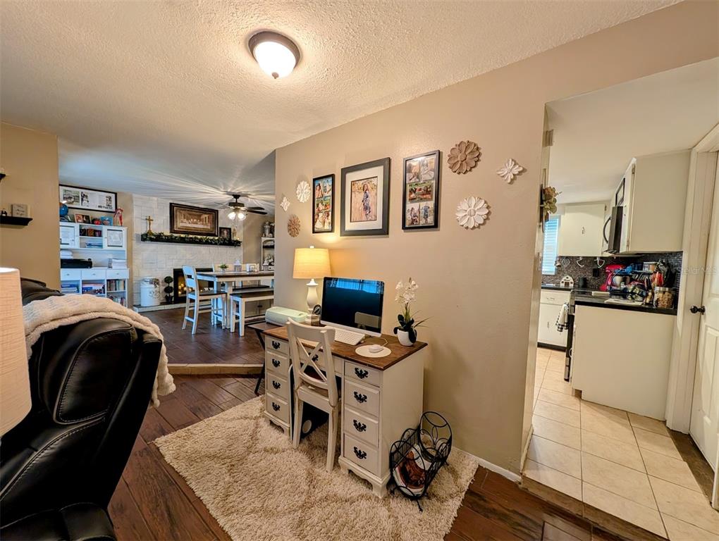A home office area sits between a living room with a fireplace and a kitchen — 8240 PENWOOD DRIVE, PORT RICHEY, FL