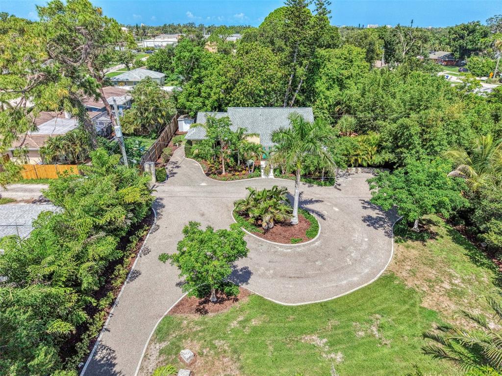 An aerial view shows a house with a circular driveway and lush landscaping — 2137 WORRINGTON STREET, SARASOTA, FL