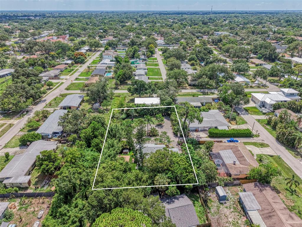 An aerial view shows a residential property outlined in white, surrounded by trees and houses — 2137 WORRINGTON STREET, SARASOTA, FL