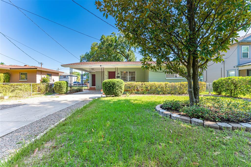 A single-story house with a carport and a large tree in the front yard — 506 E SPARKMAN AVENUE, TAMPA, FL