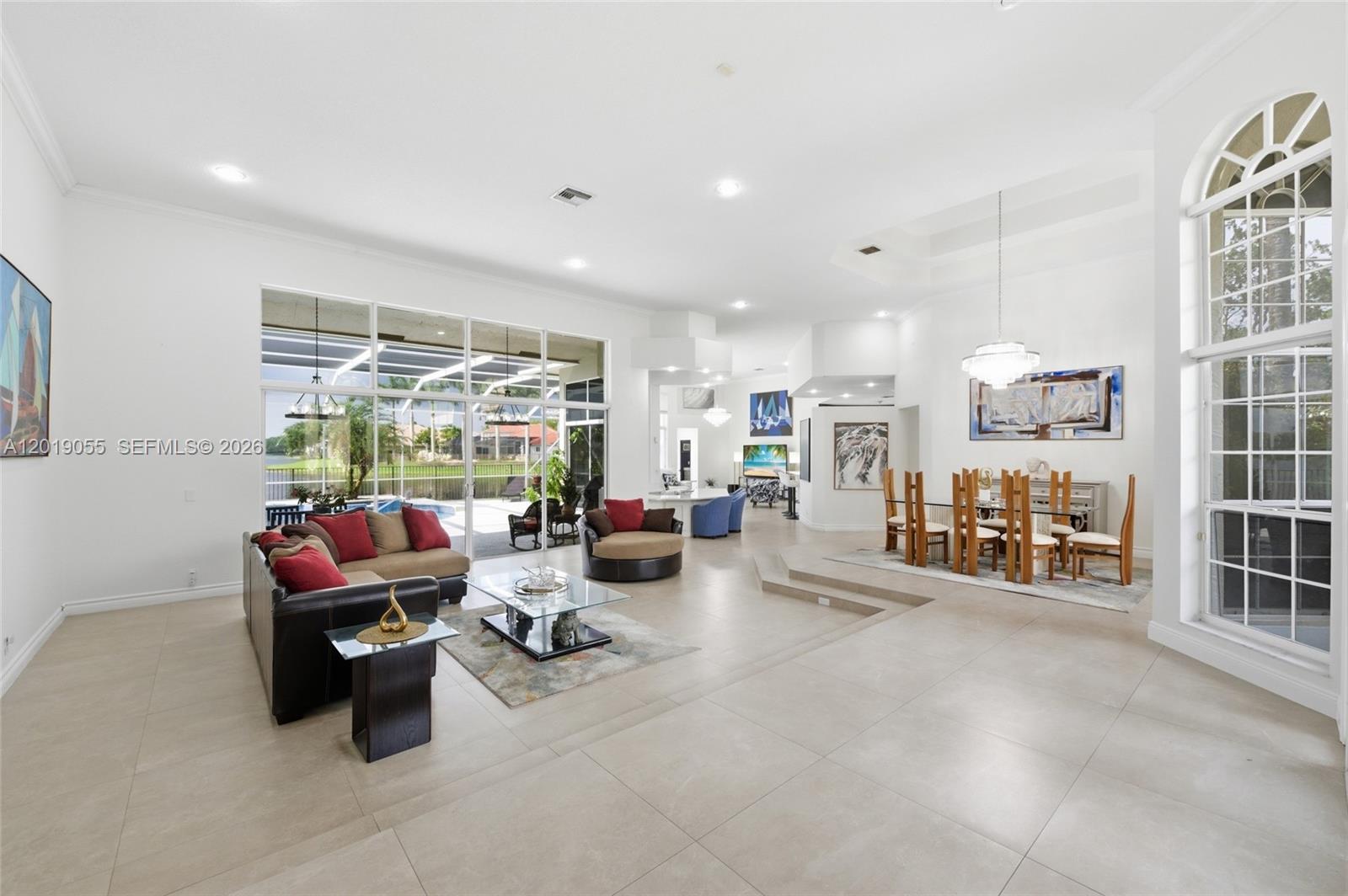 A spacious living and dining area features tile floors, high ceilings, and large glass doors — 2926 Medinah, Weston FL 33332, WESTON, FL