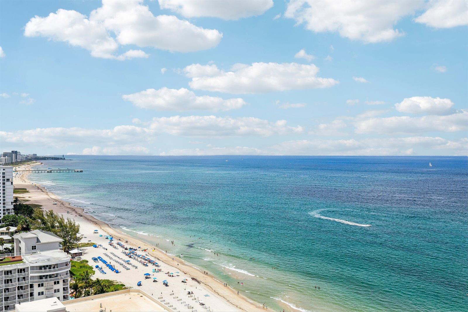 An aerial view of a sandy beach with blue ocean water and a coastal building — 1340 S Ocean Boulevard # 2303, Pompano Beach FL 33062, POMPANO BEACH, FL