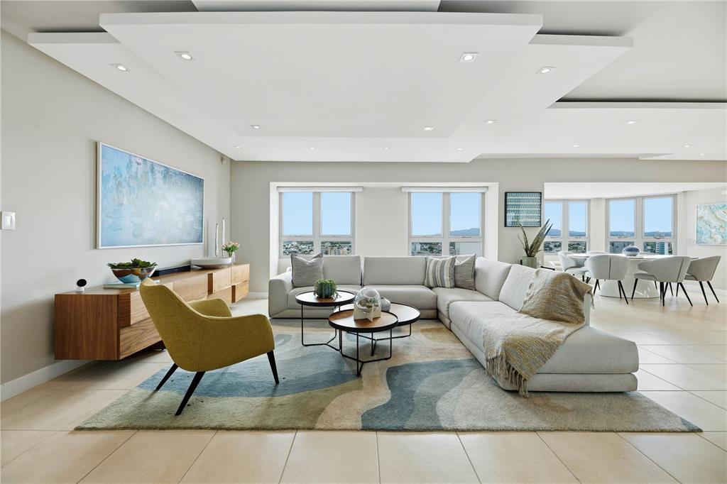 A modern living room features a sectional sofa, a yellow armchair, and a patterned rug — 103-105 DE DIEGO AVENUE UNIT 1604S, SAN JUAN, PR