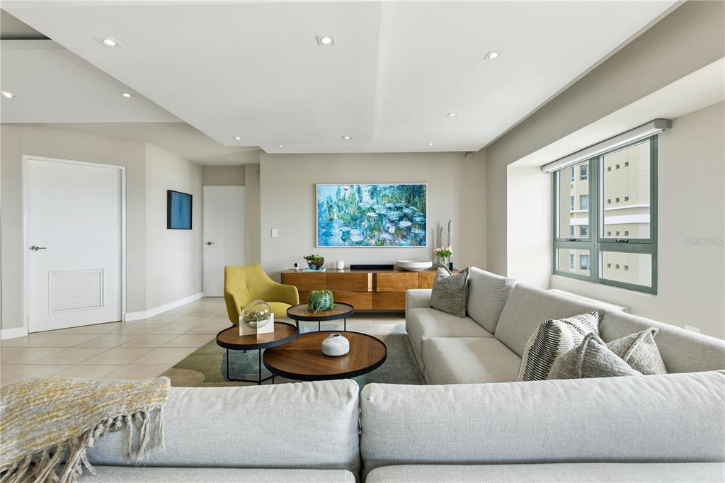 A modern living room features a light gray sectional sofa, round coffee tables, and artwork — 103-105 DE DIEGO AVENUE UNIT 1604S, SAN JUAN, PR