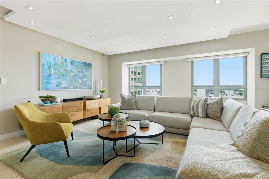 A living room features a sectional sofa, a yellow armchair, and two round coffee tables — 103-105 DE DIEGO AVENUE UNIT 1604S, SAN JUAN, PR