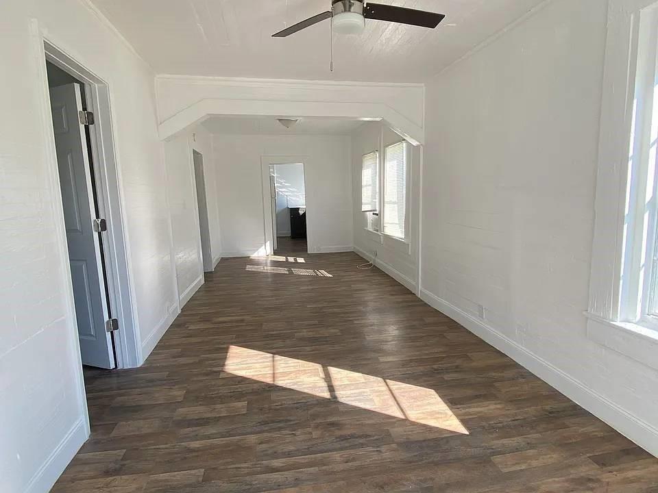 An empty room with white walls, wood-look flooring, and a ceiling fan — 4144 Herring Avenue, FL 32448, FL