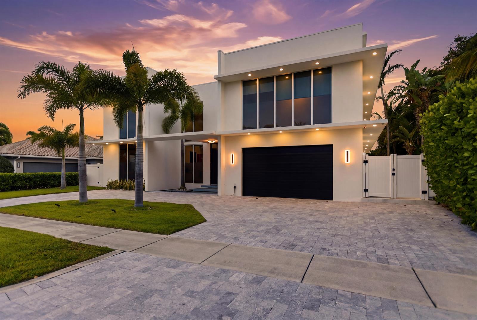 A modern two-story house with a black garage door, palm trees, and a paved driveway — 284 NE 7th Street, Boca Raton FL 33432, BOCA RATON, FL
