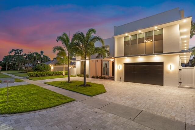 A modern two-story house with a paved driveway, palm trees, and a dark garage door — 284 NE 7th Street, Boca Raton FL 33432, BOCA RATON, FL