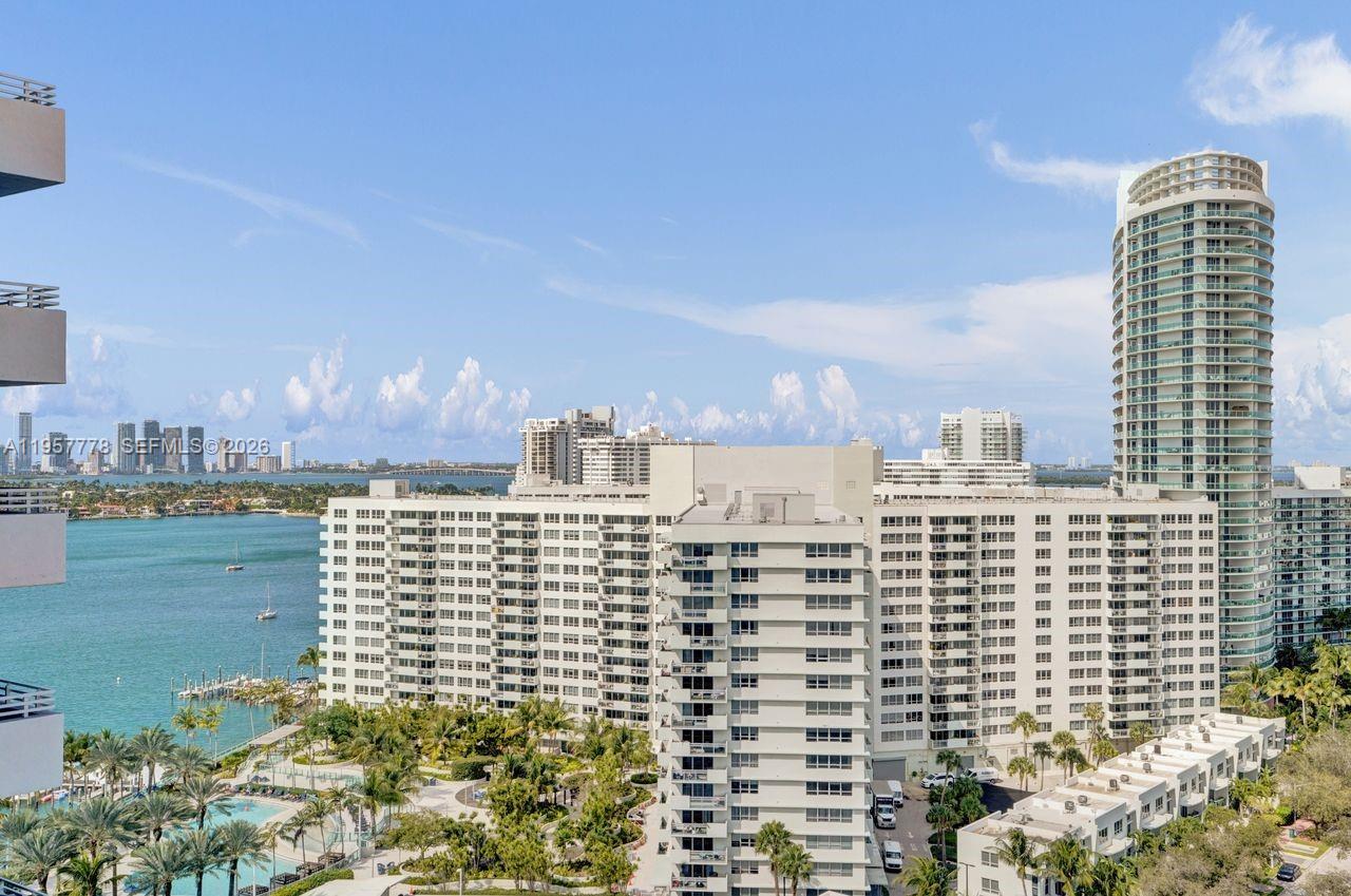 An elevated view shows a large white apartment complex next to a tall cylindrical tower — 1330 West Ave # 1811, Miami Beach FL 33139, MIAMI BEACH, FL
