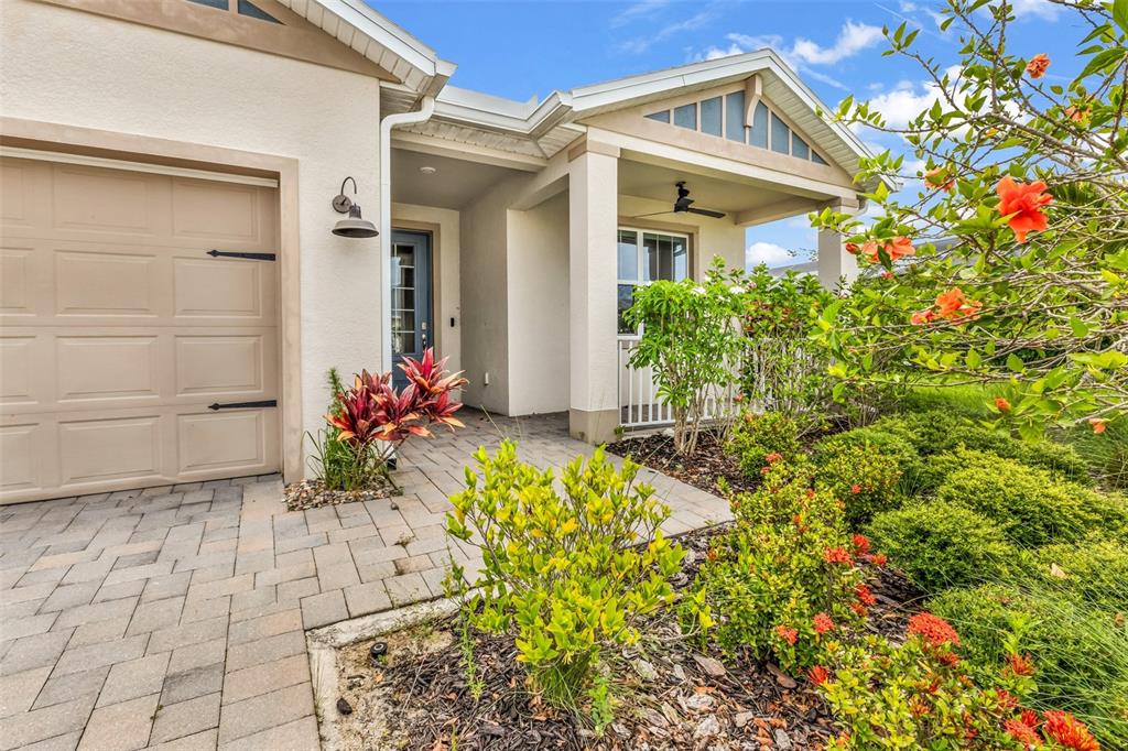 A paved walkway leads to the front entrance and garage of a suburban home — 16121 LOTUS WAY, PUNTA GORDA, FL